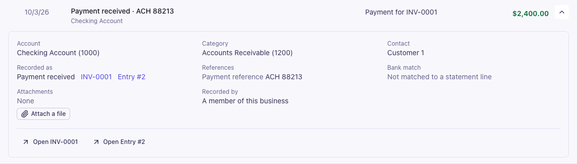 A payment received from Customer 1 opened in place, showing the account, the category, the contact, links to INV-0001 and the journal entry, the payment reference, the bank match, attachments with Attach a file, and who recorded it